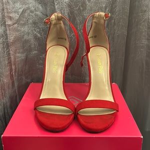 Red stiletto high heels, size 6 1/2 only worn one time in perfect condition.